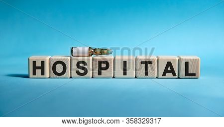 Hospital - Word On Cubes. Drug In Ambula To Reduce Disease Symptoms On A Blue Background