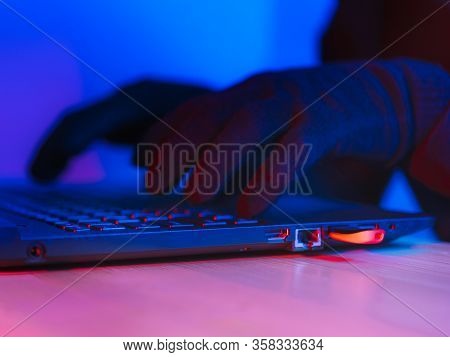 Online Theft Of Personal Data, Computer Hacking. Hacker Man Using A Laptop Attacks The Web. Personal