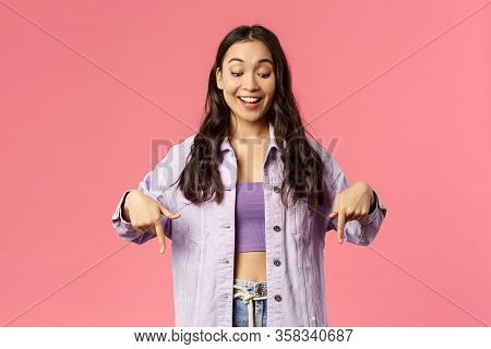 Portrait Of Curious Good-looking, Stylish Female In Denim Jacket Over Crop-top, Smiling Excited And 