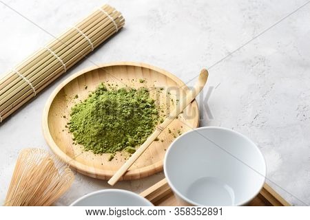 Matcha Green Powder And Tea On Gray Concrete Background