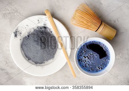 Blue Matcha Tea In Two White Cup , Wooden Tray, Bamboo Tavan And Tasaku, Powder On White Gray Backgr