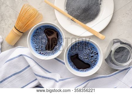 Blue Matcha Tea In Two White Cup , Wooden Tray, Bamboo Tavan And Tasaku, Powder On White Gray Backgr