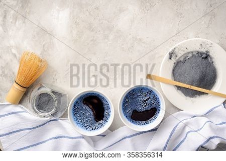 Blue Matcha Tea In Two White Cup , Wooden Tray, Bamboo Tavan And Tasaku, Powder On White Gray Backgr