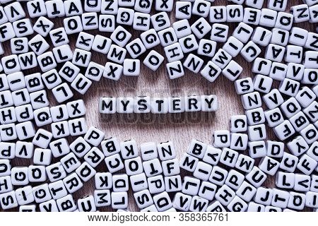 Word Mystery Written In English With Square White And Black Letters Mixed Up With All The Alphabet L