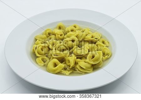 Tortellini In Brodo (broth) Isolated On White. Traditional Italian Pasta