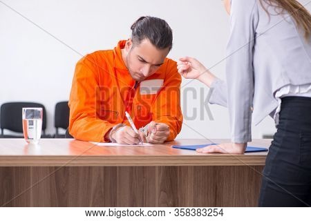Young man meeting with advocate in pre-trial detention