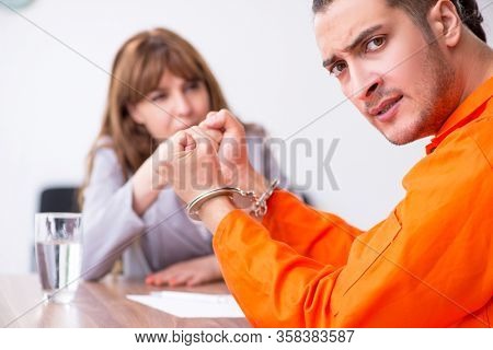 Young man meeting with advocate in pre-trial detention