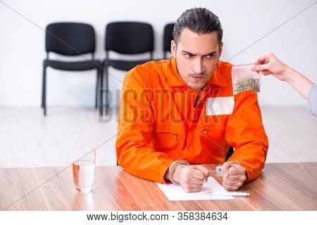 Young man meeting with advocate in pre-trial detention
