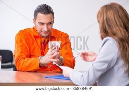 Young man meeting with advocate in pre-trial detention