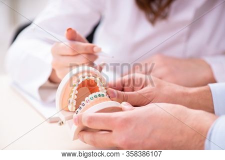 Young male doctor stomatologist and female student in the classr