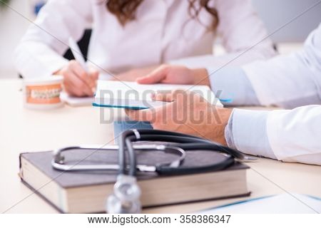 Young male doctor stomatologist and female student in the classr