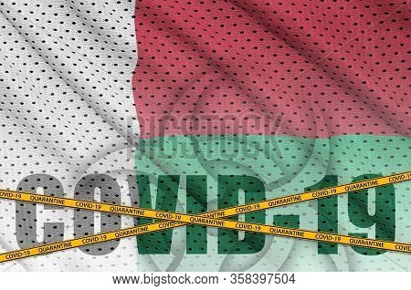 Madagascar Flag And Covid-19 Inscription With Orange Quarantine Border Tape. Coronavirus Or 2019-nco