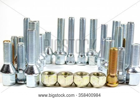 Nuts And Upright Studs And Bolts For A Car On A Table With A Place For Inscription