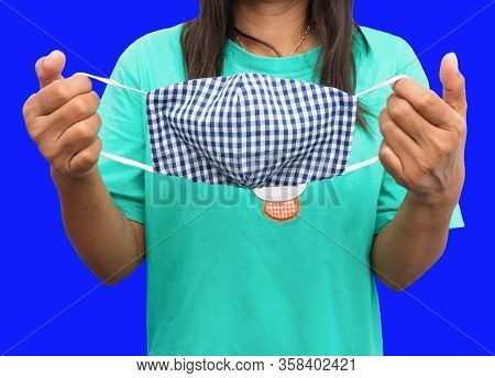 Hand Hold Mask Fabric Striped Blue - White Homemade Prophylaxis Virus Over Blue Background. Prevent 