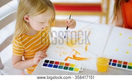 Cute Girl Drawing With Colorful Paints. Creative Kid Painting At Home. Education And Distance Learni