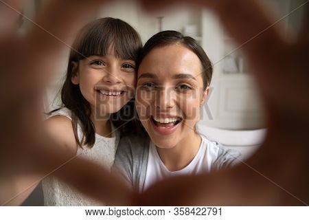 Portrait Of Happy Mom And Small Daughter Make Selfie Together