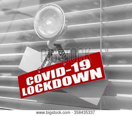 Red Warning Sign For Covid-19 In Front Of Closed Shop / Office. Lockdown. Concept Of Stop Working Ac