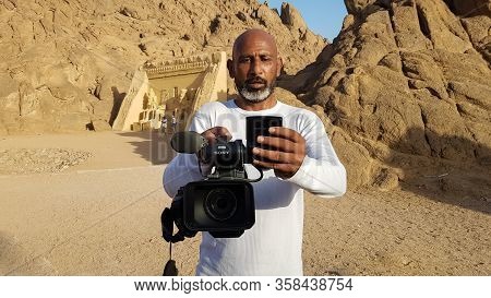 Egypt, Sharm El Sheikh - March 30, 2020. An Adult Black Egyptian Videographer With A Sony Camcorder 
