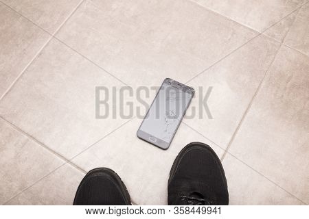 The Black Smartphone Fell Out Of My Hands And The Screen Crashed To Smithereens.