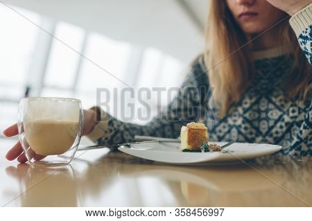 Closeup Of Glass With Double Bottom With Coffee And Peace Of Dessert And Leaf Of Mint On White Plate