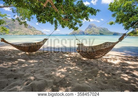 El Nido, Palawan, Philippines. Bamboo Hammocks On Shore In The Shade. Beautiful Tropical Lagoon With