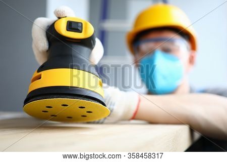 Masked Builder Polishes Sander Wooden Surface. Rotational And Oscillatory Movements Equipment. Elect