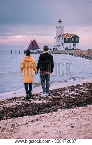 Paard Van Marken Lighthouse In The Netherlands, Couple Visiting The Fishing Village Of Marken Hollan