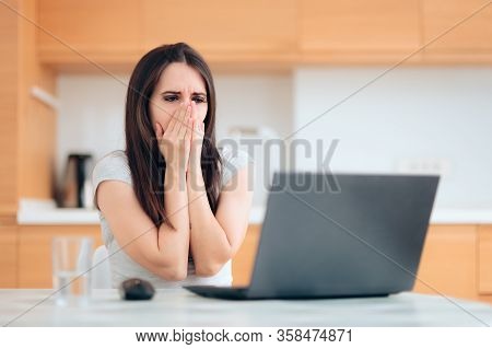 Worried Woman Reading The News At Home In The Kitchen