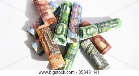 Rolled Up Euro Bills, Euro Banknotes Rolled Up On A White Background Several Hundred Euros On White 