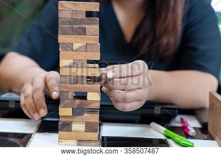Growing Business Concept. Business Woman Picking Domino Blocks For Filling The Missing Dominus And P