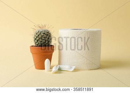 Toilet Paper, Candles And Cactus On Beige Background. Hemorrhoids