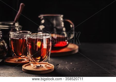 Cup Of Freshly Brewed Black Tea, Dark Moody, Tea Ceremony. Hot Water Is Poured From The Kettle Into 