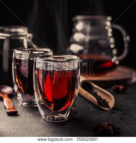 Cup Of Freshly Brewed Black Tea, Dark Moody, Tea Ceremony. Hot Water Is Poured From The Kettle Into 