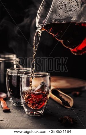 Process Brewing Tea, Tea Ceremony, Cup Of Freshly Brewed Black Tea, Dark Moody.hot Water Is Poured F