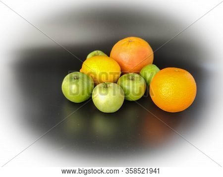 Whole Fruits Green Apples, Orange, Grapefruit And Lemon On Black Background. Concept - Vegetarian An