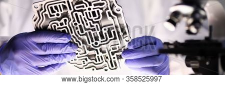 Man Holds Metal Part From Automatic Transmission. Transmission Service Repair Center Master Identifi