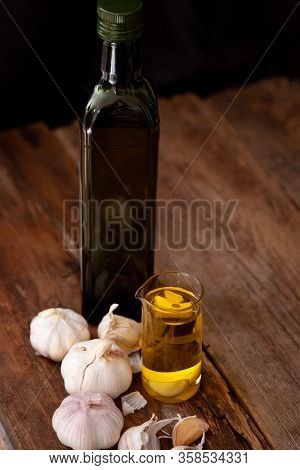 Garlic On A Wooden Background. Food On Table.