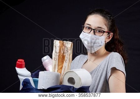 Young Woman In Protective Mask With A Bag Full Of Groceries From The Supermarket