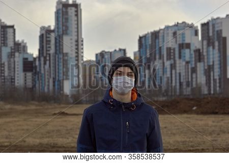 Teen Wearing A Medical Mask Against The Background Of A City Against Quarantine Selective Focus