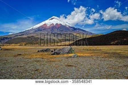 View Of The Cotopaxi Volcano On A Sunny Morning, With Volcanic Rocks In The Foreground. Cotopaxi Nat
