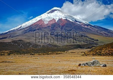 View Of The Cotopaxi Volcano On A Sunny Morning, With Volcanic Rocks In The Foreground. Cotopaxi Nat
