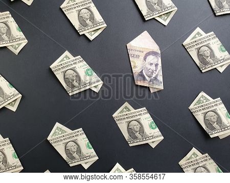 American One Dollar Bills And Uruguayan Banknote Of 100 Pesos On The Black Background