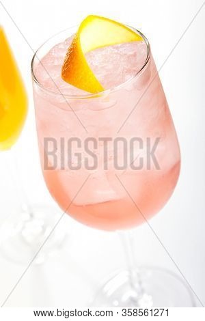 Raspberry french cocktail close up. Alcohol drink in glass top view. Beverage with rose gin and prosecco wine in drinkware. Exotic French Martini cocktail portion with crushed ice in glassware