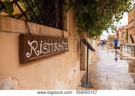 Venice, Italy - September 9, 2019: Signboard With Ristorante Lettering On Wet City Street Water Chan