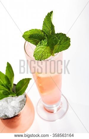 Breakfast fizz cocktail close up. Alcohol strong drink in glass side view. Beverage with gin, egg white and fruits in drinkware. Cocktail portion decorated with berries in glassware