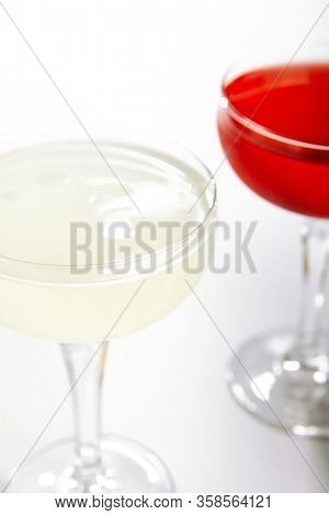 Tropical daiquiri cocktail close up. Alcohol strong drink in glass side view. Beverage with rum and fruit juice in drinkware. Summer beach exotic cocktail portion with crushed ice in glassware