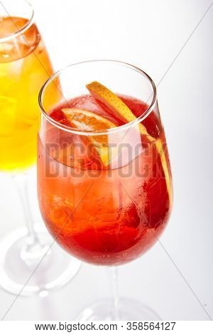 Rose Spritz cocktail. Alcohol soft drinks in glasses side view. Refreshment beverage with rose lemonade in drinkware. Exotic summer beach cocktail portions with crushed ice in glassware