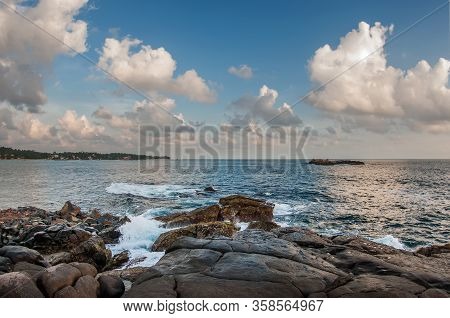 Waves Break On The Coastal Rocks.g  Turquoise Sea Water, Blue Sky And Snow-white Clouds. Sri Lanka.
