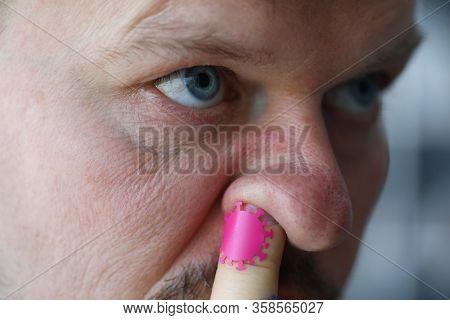 Man Put His Finger In Nose Coronavirus Germs. Attack By Mucous Membrane Upper Respiratory Tract. Moi