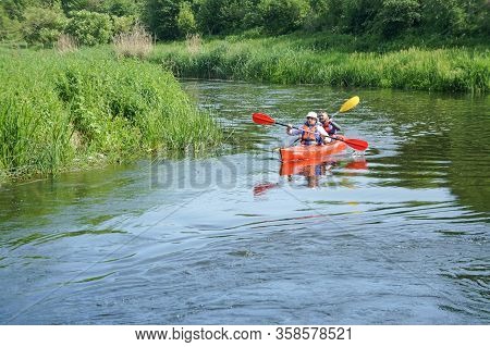 A Man Floating On A Kayak, Tourists To Raft On A Canoe On The River, Angrapa River, Kaliningrad Regi